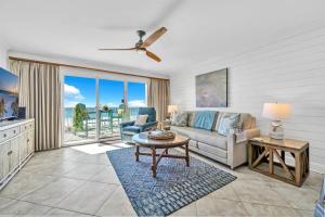 a living room with a couch and a table at Gulf Dunes 305 Coastal Dream in Fort Walton Beach