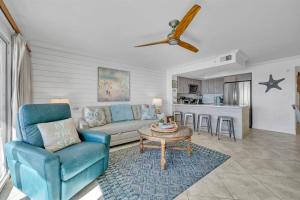 a living room with a couch and a table at Gulf Dunes 305 Coastal Dream in Fort Walton Beach
