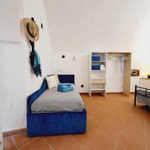 a bedroom with a blue bed in a room at Casetta 18 in Porto Ercole
