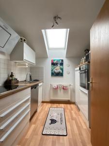 a kitchen with a sink and a kitchen rug on the floor at Ferienwohnung Seidenhuhn in Kiefersfelden