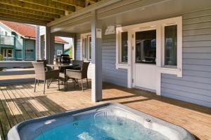 a jacuzzi tub on a porch of a house at Finest Retreats - Puddleduck 