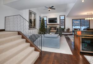 a living room with a staircase and a fireplace at Wildflower Place Unit 5 in Edwards