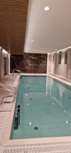 a large swimming pool in a building at Holiday Sunset Blvd Apartment for Two in Darłowo