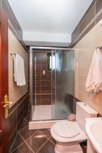 a bathroom with a shower and a toilet and a sink at Etno selo Stanišići Hotel Pirg in Dvorovi