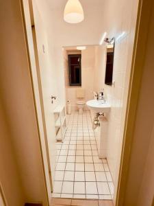 a white bathroom with a sink and a toilet at Loft with Gym - Kitchen / WiFi / Free Parking in Berlin