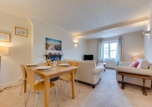 a living room with a table and a couch at Alma Rise in Melton