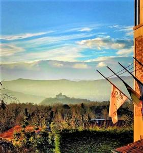 a view of a view of a valley from a building at B&B Relais Cascina al Campaccio in Taino