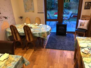 a dining room with a table and chairs and a door at Woodview House Bed and Breakfast in Cork