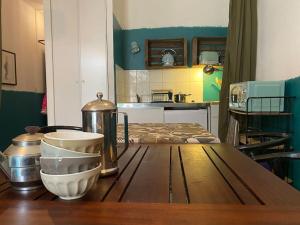 a kitchen with a wooden table with a counter top at Invitation au voyage sur cour in Sète