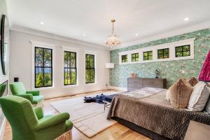 a bedroom with a bed and a chair and windows at Luxury Mountain Mansion, 7BR, 8 king beds, 10000sf, Views, Pool, Sport Court, Gym, Sauna, Petting Zoo in Blue Ridge +67 photos