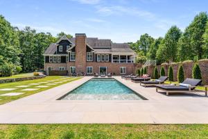 a house with a swimming pool in the yard at Luxury Mountain Mansion, 7BR, 8 king beds, 10000sf, Views, Pool, Sport Court, Gym, Sauna, Petting Zoo in Blue Ridge