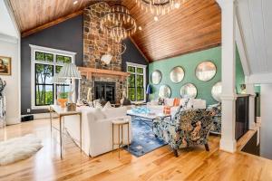 a living room with a couch and a fireplace at Luxury Mountain Mansion, 7BR, 8 king beds, 10000sf, Views, Pool, Sport Court, Gym, Sauna, Petting Zoo in Blue Ridge
