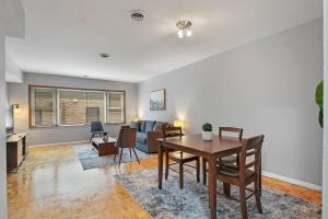 a living room with a table and a couch at Prime 2-Bedroom Oasis - Church 304 in Evanston