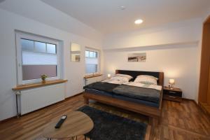 a bedroom with a large bed and a table at Ferienhaus Auszeit in Westoverledingen