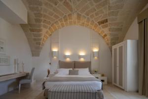 Ein Bett oder Betten in einem Zimmer der Unterkunft Baglioni Masseria Muzza Resort & Spa