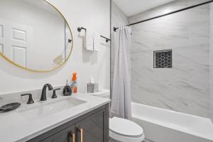 La salle de bains est pourvue d'un lavabo, de toilettes et d'une baignoire. dans l'établissement Good Shepard Homestay, à Los Angeles