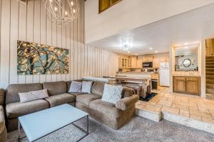 a living room with a couch and a table at Courchevel 57 in Mammoth Lakes