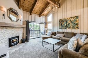 a living room with a couch and a fireplace at Courchevel 57 in Mammoth Lakes