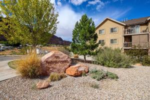 a garden in front of a building with a sign at Red Cliff 3J in Moab