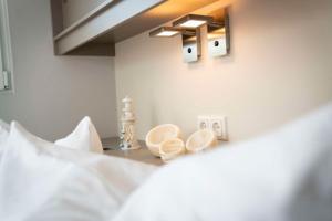 a bedroom with a bed with a light switch and a table at Hausboot Albatros - LP4 in Laasow