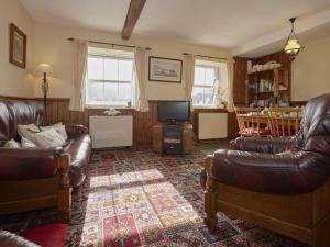 a living room with leather furniture and a television at 2 Bed in Wasdale SZ551 in Nether Wasdale