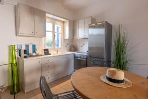 a kitchen with a table with a hat on it at ACOYA SUMMER HOME in Kampos Paros