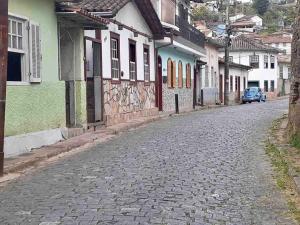 a cobblestone street in a town with buildings at Casa Antônio Dias in Ouro Preto