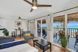 a living room with a bed and a balcony with the ocean at Beach Condo - Hollywood Beachfront and Broadwalk in Hollywood