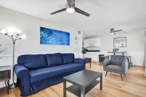 a living room with a blue couch and a kitchen at Beach Condo - Hollywood Beachfront and Broadwalk in Hollywood +22 photos