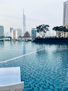 a swimming pool with a view of a city at Sentral Luxury Suites KL in Kuala Lumpur