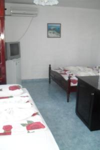 a room with two beds and a tv in it at Family Hotel Sinemoretz in Sinemorets +29 photos