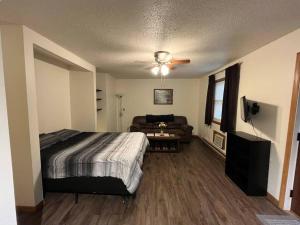 a bedroom with a bed and a couch at Tomah Apartment - 201 E Veterans Unit J in Tomah