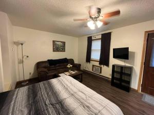a living room with a bed and a couch at Tomah Apartment - 201 E Veterans Unit J in Tomah