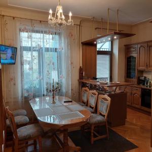 a kitchen with a table and chairs and a dining room at Luxury Apartments Darvina Street in Kyiv