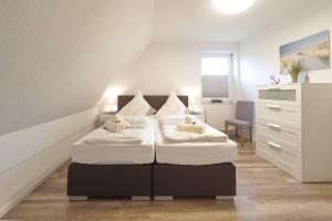 Un pat sau paturi într-o cameră la Up Süderdün 15 - Whg 2