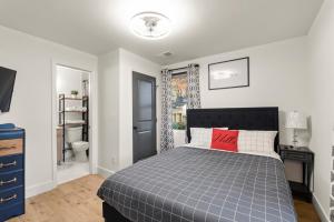 a bedroom with a bed and a bathroom with a window at New Decatur Bungalow in Decatur