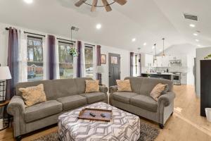 a living room with two couches and a table at New Decatur Bungalow in Decatur