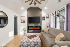 a living room with a couch and a fire place at New Decatur Bungalow in Decatur