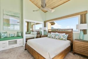 a bedroom with a bed and a window at Renovated 2br Condo with Ocean Views - Alekona Kauai in Koloa +15 photos