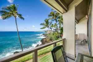 a balcony with a view of the ocean at Unique Oceanfront Condo with AC- Alekona Kauai in Koloa