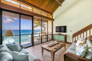 a living room with a view of the ocean at Unique Oceanfront Condo with AC- Alekona Kauai in Koloa