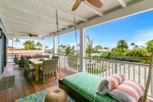 a porch with a bed and a table on a deck at 4BR Poipu Home with Private Pool- Alekona Kauai in Koloa