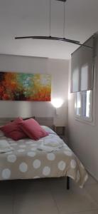 a bedroom with a bed with a painting on the wall at Loft Mag in Fanano