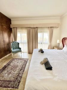 a bedroom with a bed with a chair and a window at DARÏ in Dubai