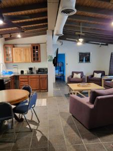 a living room with a couch and a table at Tillett Gardens Guest House & Hostel in Nazareth