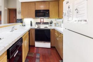 a kitchen with a stove and a refrigerator at Snowcreek 847 in Mammoth Lakes