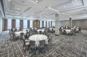 a banquet hall with white tables and chairs at Hilton London Croydon in Croydon