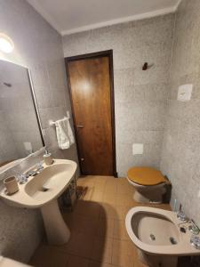 a bathroom with a sink and a toilet and a mirror at LUAMAR 2-SAINT MICHELE in Mar del Plata +7 photos