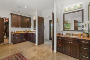 a bathroom with two sinks and a large mirror at Custom 4br Home Walking Distance to Beach - Alekona Kauai in Koloa +49 photos