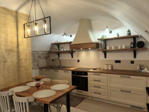 a kitchen with a table with chairs and a stove at Tsolakis Luxury House 2 in Leonidio